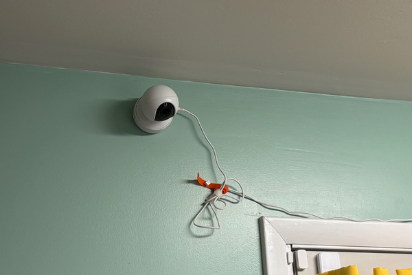 Camera affixed to indoor wall that points at cat food and litter area