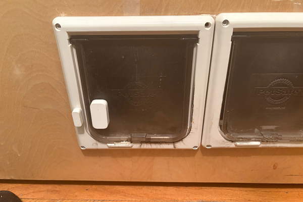 Contact sensors affixed to the doggy door flaps