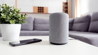 Smart speaker on living room table ready for voice commands