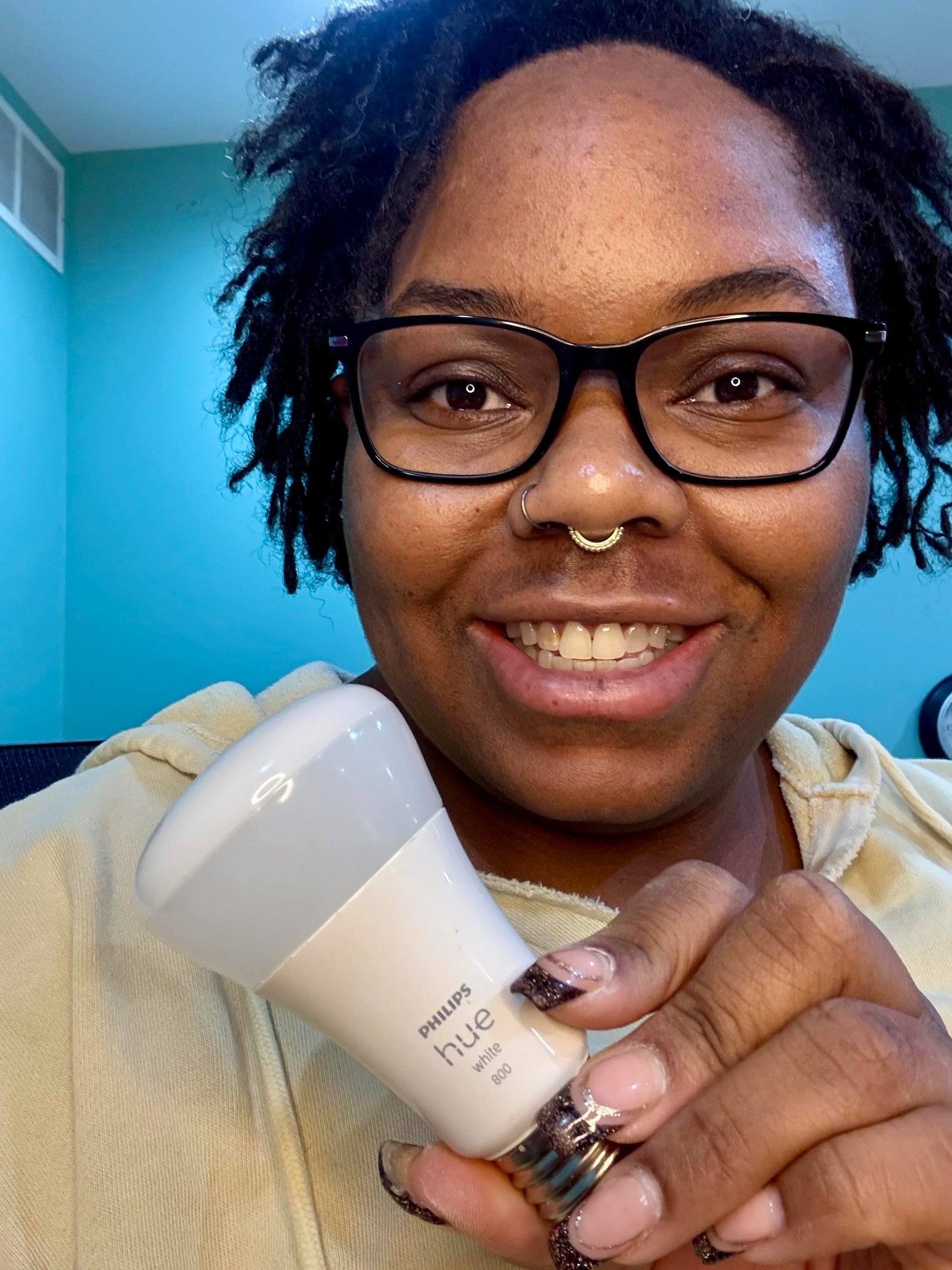 Image of Ashley holding a smart light bulb