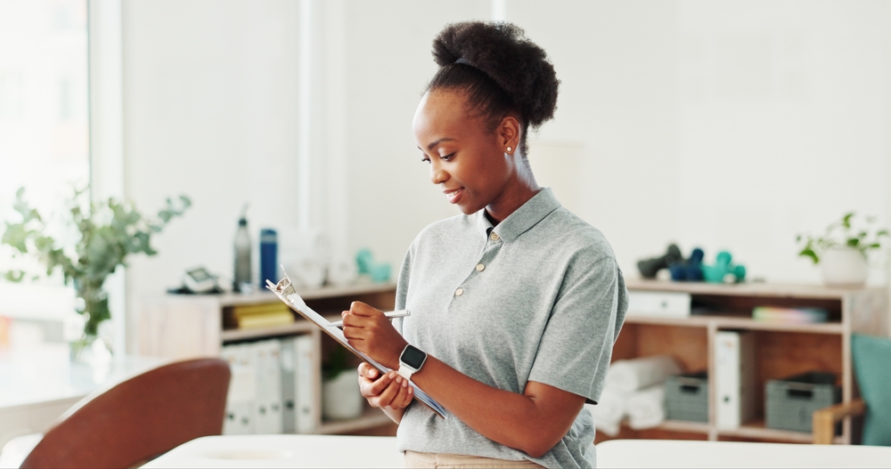 Consultant taking detailed notes during a home safety assessment