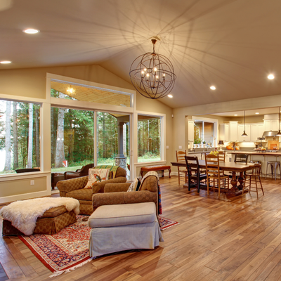 View of well-lit living room and kitchen